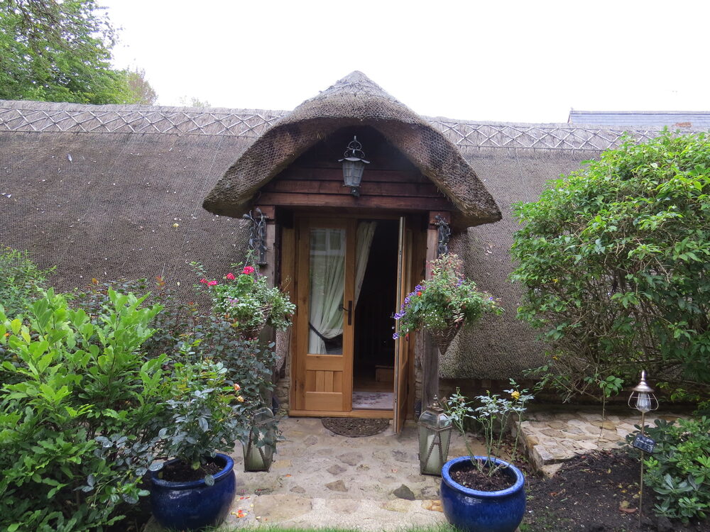 The arched front door under the thatch