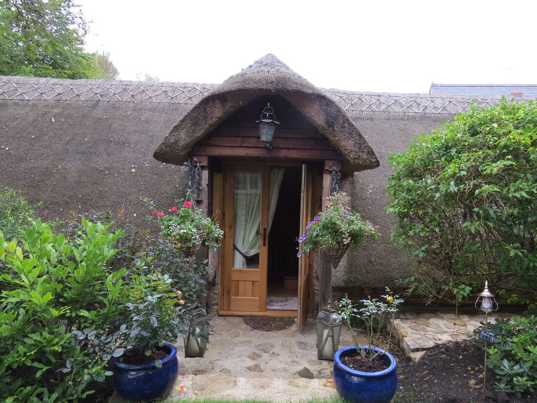 The thatched doorway of The Barn by the Ford